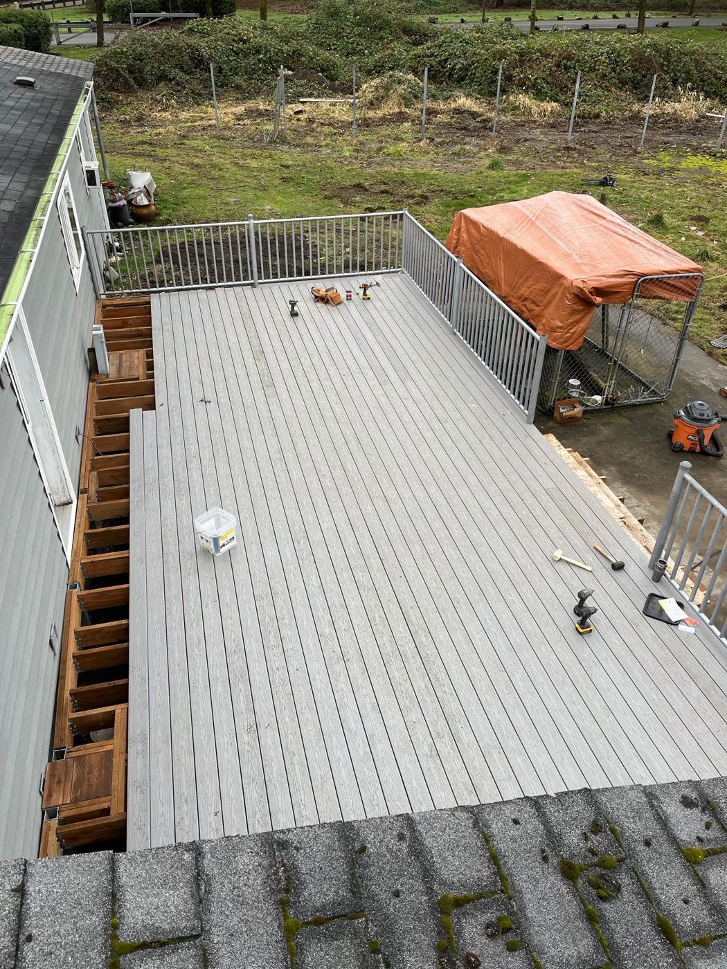 Large gray composite deck with aluminum railing, seen from above